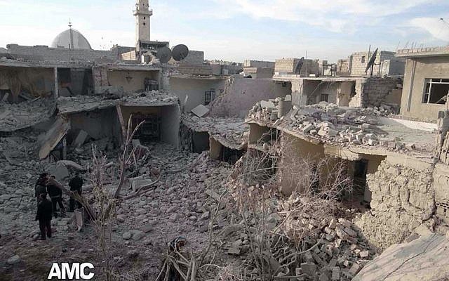 This citizen journalism image provided by Aleppo Media Center, AMC, which has been authenticated based on its contents and other AP reporting, Syrian citizens stand on rubble of houses that were destroyed due to Syrian forces airstrikes in Aleppo, Syria, Wednesday, Dec. 18, 2013. (photo credit: AP Photo/Aleppo Media Center AMC) This citizen journalism image provided by Aleppo Media Center, AMC, which has been authenticated based on its contents and other AP reporting, Syrian citizens stand on rubble of houses that were destroyed due to Syrian forces airstrikes in Aleppo, Syria, Wednesday, Dec. 18, 2013. (photo credit: AP Photo/Aleppo Media Center AMC)