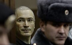 Mikhail Khodorkovsky (left), looks from behind glass at a courtroom in Moscow, Russia, on December 30, 2010. (photo credit: AP/Ivan Sekretarev, File)