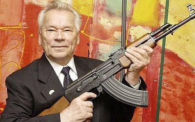 Russian weapon designer Mikhail Kalashnikov presents his legendary assault rifle to the media while opening the exhibition 'Kalashnikov - legend and curse of a weapon' at a weapons museum in Suhl, Germany, July 26, 2002. (AP/Jens Meyer)
