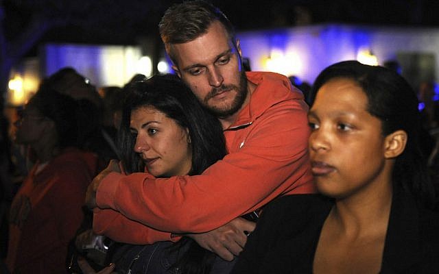 A group of mourners outside the Johannesburg home of former president Nelson Mandela on Friday, December 6, 2013. (photo credit: AP/Denis Farrell)