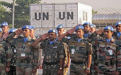 UN peacekeepers salute during a memorial service for two colleagues who were killed in an attack on the UN compound in Juba, South Sudan, Saturday, Dec. 21, 2013. (AP/United Nations Mission in South Sudan)