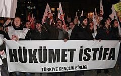 Protesters shout slogans as they carry a banner that reads "Government, resign" in Ankara, Turkey, in December (photo credit: AP/Burhan Ozbilici)