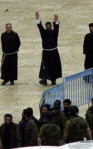 A priest reacts as the last group of Palestinians leave Bethlehem's Church of the Nativity May 10, 2002 under a deal intended to end a five-week armed standoff at one of Christianity's holiest shrines (photo credit: Gil Yohanan/Flash90)