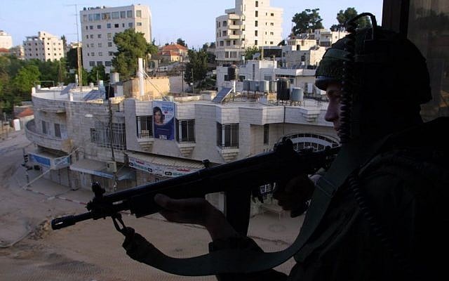 An Israeli soldier stands guard near the Church of the Nativity in Bethlehem, the scene of a stand-off between the Israeli army and a group of Palestinians who had taken refuge inside the Church, April 14, 2002 (photo credit: Flash90)