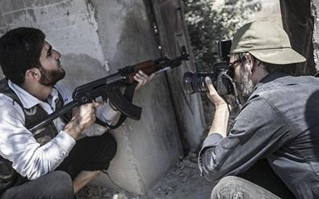 Spanish photographer Ricardo Garcia-Vilanova, right, who was kidnapped in Syria 11 weeks ago takes photographs of a Free Syrian Army fighter in Aleppo, Syria. (AP Photo/Narciso Contreras) Spanish photographer Ricardo Garcia-Vilanova, right, who was kidnapped in Syria 11 weeks ago takes photographs of a Free Syrian Army fighter in Aleppo, Syria. (AP Photo/Narciso Contreras)