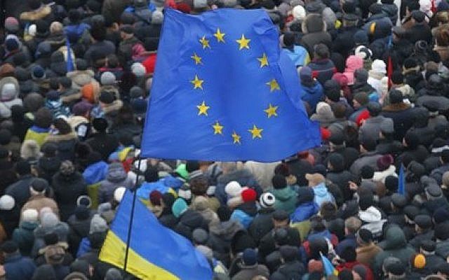 European Union and Ukrainian national flags fly above a crowd of Pro-European Union activists gathered during a rally in Independence Square in Kiev, Ukraine, Sunday, Dec. 8, 2013 (photo credit: AP/Sergei Grits) European Union and Ukrainian national flags fly above a crowd of Pro-European Union activists gathered during a rally in Independence Square in Kiev, Ukraine, Sunday, Dec. 8, 2013 (photo credit: AP/Sergei Grits)