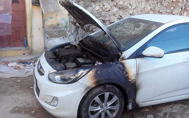 A car burned in an apparent 'price tag' attack in the Palestinian village of Madama, in the northern West Bank, January 8, 2014. (photo credit: Rabbis For Human Rights)