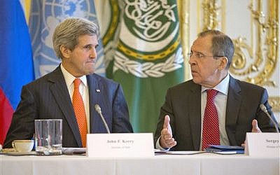 U.S. Secretary of State John Kerry, left, listens to Russia's Foreign Minister Sergey Lavrov before the start of their joint meeting with U.N.-Arab League envoy for Syria Lakhdar Brahimi at the U.S. ambassador's residence in Paris, France, Monday, January 13, 2014. (photo credit: AP/Pablo Martinez Monsivais, Pool)