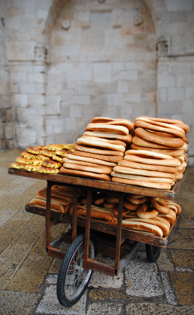 Michelle Abramson took this untitled photo taken in the Old City of Jerusalem: "This photo was taken right at the entrance of the old city of Jerusalem. As you walk through the gate and enter the cobbled streets, a street vendor sits there with a cart of this long shaped bread piled high." (photo credit: Michelle Abramson)