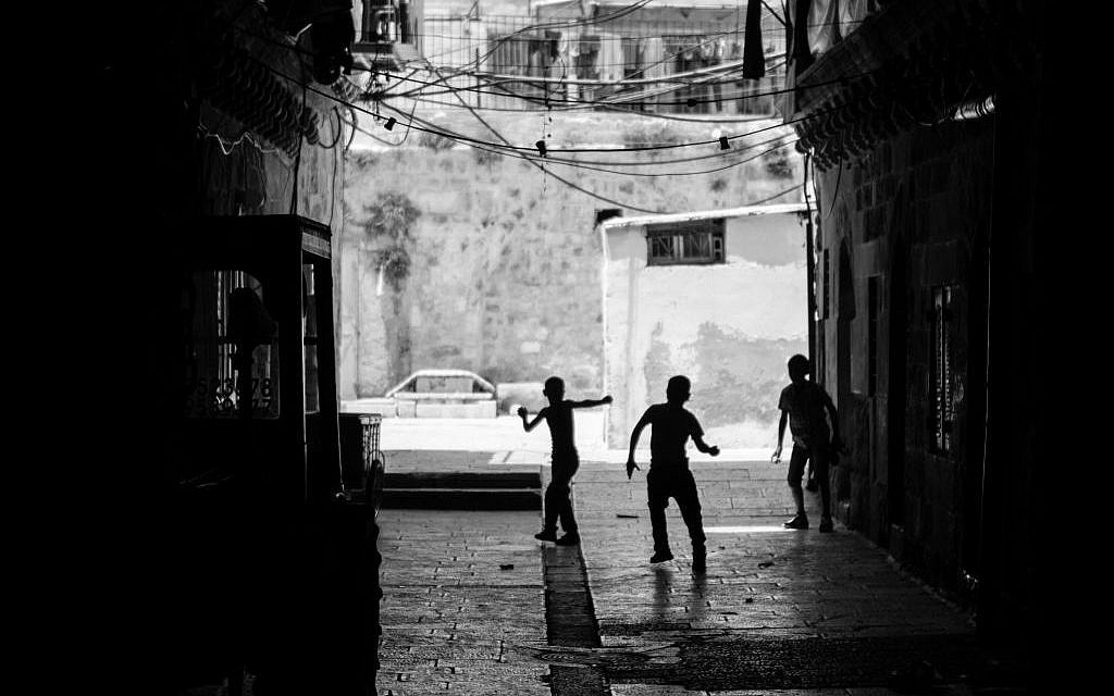 The Best in Show winner. Derek Doneen snapped this photo, 'The Youth,' while walking through Jerusalem's Old City. 'I can't pin down what exactly inspired the photo. To me, photography is an immediate reaction. I'm more interested in capturing real, human moments than I am in setting up posed pictures. Photographs are fractions of seconds. I was so humbled walking through the Old City and thinking about the history surrounding me -- how much this particular area means so much to so many people. It's been a place of tremendous loss and horrific conflict and yet, brought immense joy to so
many others. Here are three kids playing in an ally -- oblivious to all of that. They could be Israeli or Palestinian, maybe both. It doesn't matter. There's innocence and purity that comes along with being a child that's captured in this picture.' (photo credit: Derek Doneen) The Best in Show winner. Derek Doneen snapped this photo, 'The Youth,' while walking through Jerusalem's Old City. 'I can't pin down what exactly inspired the photo. To me, photography is an immediate reaction. I'm more interested in capturing real, human moments than I am in setting up posed pictures. Photographs are fractions of seconds. I was so humbled walking through the Old City and thinking about the history surrounding me -- how much this particular area means so much to so many people. It's been a place of tremendous loss and horrific conflict and yet, brought immense joy to so
many others. Here are three kids playing in an ally -- oblivious to all of that. They could be Israeli or Palestinian, maybe both. It doesn't matter. There's innocence and purity that comes along with being a child that's captured in this picture.' (photo credit: Derek Doneen)