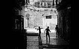 The Best in Show winner. Derek Doneen snapped this photo, 'The Youth,' while walking through Jerusalem's Old City. 'I can't pin down what exactly inspired the photo. To me, photography is an immediate reaction. I'm more interested in capturing real, human moments than I am in setting up posed pictures. Photographs are fractions of seconds. I was so humbled walking through the Old City and thinking about the history surrounding me -- how much this particular area means so much to so many people. It's been a place of tremendous loss and horrific conflict and yet, brought immense joy to so 
many others. Here are three kids playing in an ally -- oblivious to all of that. They could be Israeli or Palestinian, maybe both. It doesn't matter. There's innocence and purity that comes along with being a child that's captured in this picture.' (photo credit: Derek Doneen)