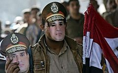 An Egyptian street vendor sells masks of Abdel-Fattah el-Sissi in Cairo, January 15, 2014. (photo credit: Khaled Desouki/AFP)