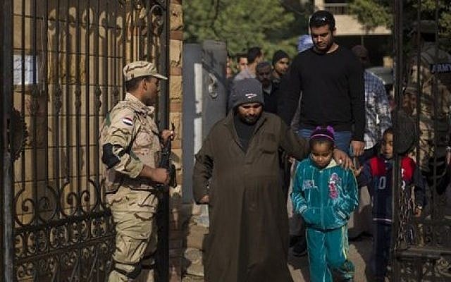 Egyptians walk into a polling center to vote in the country's constitutional referendum, in Cairo, Egypt, Wednesday, January 15, 2014 (photo credit: AP/Khalil Hamra) Egyptians walk into a polling center to vote in the country's constitutional referendum, in Cairo, Egypt, Wednesday, January 15, 2014 (photo credit: AP/Khalil Hamra)