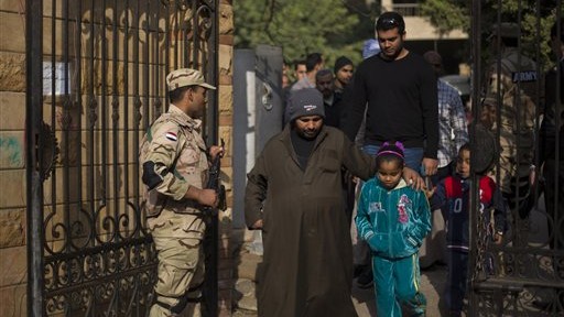 Egyptians walk into a polling center to vote in the country's constitutional referendum, in Cairo, Egypt, Wednesday, January 15, 2014 (photo credit: AP/Khalil Hamra) Egyptians walk into a polling center to vote in the country's constitutional referendum, in Cairo, Egypt, Wednesday, January 15, 2014 (photo credit: AP/Khalil Hamra)