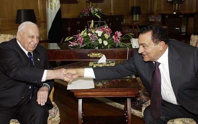 Prime minister Ariel Sharon, left, and Egyptian President Hosni Mubarak shake hands during a meeting at the Red Sea resort of Sharm el-Sheik, Egypt, Tuesday Feb. 8, 2005. (photo credit: AP Photo/Avi Ohayon/Government Press Office)