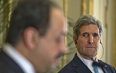 US Secretary of State John Kerry, right, listens to Qatar's Foreign Minister Khalid al-Attiyah, left, during their joint news conference at the US Ambassador's residence in Paris, France, Sunday, Jan. 12, 2014 (photo credit: AP/Pablo Martinez)