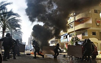 Egyptian security forces clash with supporters of ousted president Mohammed Morsi in the Nasr City district of Cairo, Egypt, January 10, 2014 (photo credit: AP/Ahmed Abd El Latif, El Shouk newspaper)