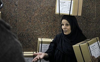 An Egyptian worker carries boxes of ballots at the Giza courthouse, in Cairo, Egypt, Monday. (AP Photo/Amr Nabil)