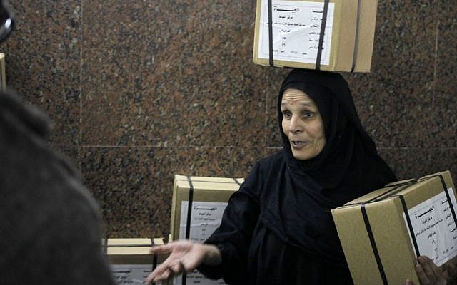 An Egyptian worker carries boxes of ballots at the Giza courthouse, in Cairo, Egypt, Monday. (AP Photo/Amr Nabil) An Egyptian worker carries boxes of ballots at the Giza courthouse, in Cairo, Egypt, Monday. (AP Photo/Amr Nabil)