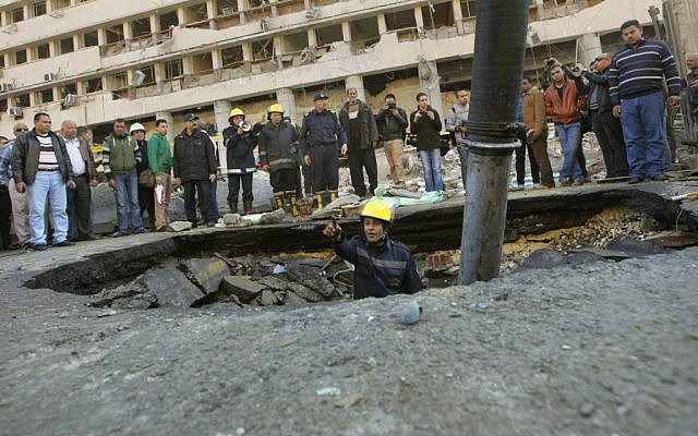 An Egyptian firefighter checks a crater made by a blast at the Egyptian police headquarters in downtown Cairo, Egypt, Friday, Jan. 24, 2014 (photo credit: AP/Amr Nabil) An Egyptian firefighter checks a crater made by a blast at the Egyptian police headquarters in downtown Cairo, Egypt, Friday, Jan. 24, 2014 (photo credit: AP/Amr Nabil)