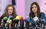 Russian punk band Pussy Riot members Nadezhda Tolokonnikova, right, and Maria Alekhina smile during their news conference in Moscow, Russia, on Friday, Dec. 27, 2013. Tolokonnikova and Alekhina were granted amnesty on Monday, Dec. 23, two months short of their scheduled release after spending nearly two years in prison for their protest at Moscow's main cathedral. (AP Photo/Ivan Sekretarev)