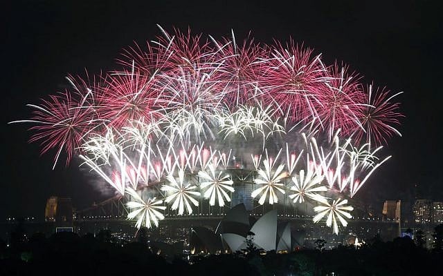 Fireworks explode over the Sydney Harbour Bridge and the Opera House during New Year's Eve celebrations in Australia,  Jan. 1, 2014. (photo credit: AP/Rob Griffith)