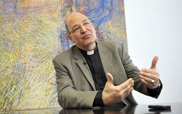 Church provost Christian Leibnitz speaks during an interview with the Associated Press on Nazi symbols on gravestones at a cemetary in Graz, Austria. (AP Photo/Hans Punz)