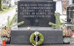 This picture taken Tuesday, Jan. 21, 2014 shows a marble tombstone which is adorned by a swastika and the inscription 'He died in the struggle for a Great Germany' at the central cemetery in Graz, Austria. (AP Photo/Hans Punz)