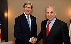 US Secretary of State John Kerry and Prime Minister Benjamin Netanyahu shake hands during their meeting on the sidelines of the World Economic Forum in Davos, Switzerland on January 24, 2014. (PMO)