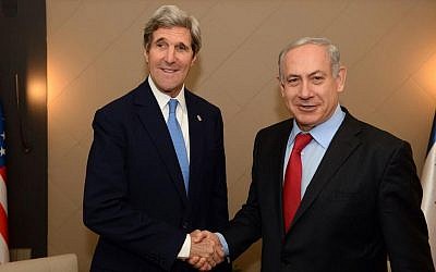 US Secretary of State John Kerry and Prime Minister Benjamin Netanyahu shake hands during their meeting on the sidelines of the World Economic Forum in Davos, Switzerland on January 24, 2014. (PMO)