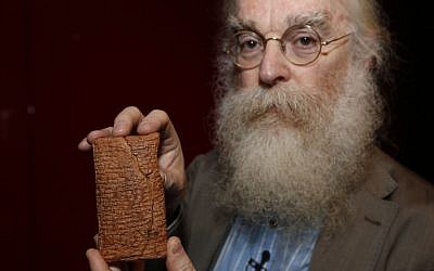 Irving Finkel, curator in charge of cuneiform clay tablets at the British Museum, poses with the 4000 year old clay tablet containing the story of the Ark and the flood during the launch of his book 'The Ark Before Noah' at the British Museum in London, Friday, Jan. 24, 2014. The book tells how he decoded the story of the Flood and offers a new understanding of the Old Testament's central narratives and how the flood story entered into it. (photo credit: AP/Sang Tan)