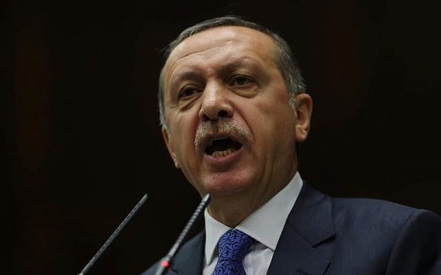 Turkish Prime Minister Tayyip Erdogan addresses members of the parliament from his ruling AK Party during a meeting at parliament in Ankara on January 28, 2014 (photo credit: AFP/Adem Altan)