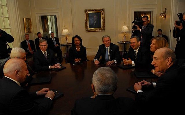 Palestinian Authority President Mahmoud Abbas (L) speaking with his chief negotiator, former Palestinian prime minister Ahmed Queria, in a round table meeting in Annapolis in November 2007 with US president George Bush and US secretary of state Condoleezza Rice, and the Israeli side led by prime minister Ehud Olmert (2,R), foreign minister Tzipi Livni and defense minister Ehud Barak. At right is Palestinian prime minister Salam Fayyad. (Photo credit: Avi Ohayon, GPO/Flash90) Palestinian Authority President Mahmoud Abbas (L) speaking with his chief negotiator, former Palestinian prime minister Ahmed Queria, in a round table meeting in Annapolis in November 2007 with US president George Bush and US secretary of state Condoleezza Rice, and the Israeli side led by prime minister Ehud Olmert (2,R), foreign minister Tzipi Livni and defense minister Ehud Barak. At right is Palestinian prime minister Salam Fayyad. (Photo credit: Avi Ohayon, GPO/Flash90)
