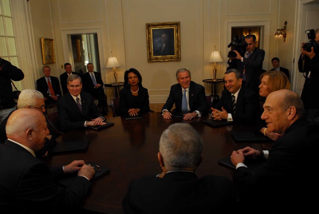 Palestinian Authority President Mahmoud Abbas (L) speaking with his chief negotiator, former Palestinian prime minister Ahmed Queria, in a round table meeting in Annapolis in November 2007 with US president George Bush and US secretary of state Condoleezza Rice, and the Israeli side led by prime minister Ehud Olmert (2,R), foreign minister Tzipi Livni and defense minister Ehud Barak. At right is Palestinian prime minister Salam Fayyad. (Photo credit: Avi Ohayon, GPO/Flash90) Palestinian Authority President Mahmoud Abbas (L) speaking with his chief negotiator, former Palestinian prime minister Ahmed Queria, in a round table meeting in Annapolis in November 2007 with US president George Bush and US secretary of state Condoleezza Rice, and the Israeli side led by prime minister Ehud Olmert (2,R), foreign minister Tzipi Livni and defense minister Ehud Barak. At right is Palestinian prime minister Salam Fayyad. (Photo credit: Avi Ohayon, GPO/Flash90)
