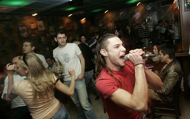 Young Immigrants from Russia sing and dance at a Karaoke evening at the Putin Bar in Jerusalem (Photo credit: Anna Kaplan/ Flash90) Young Immigrants from Russia sing and dance at a Karaoke evening at the Putin Bar in Jerusalem (Photo credit: Anna Kaplan/ Flash90)