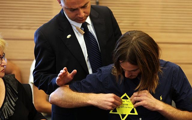 Meir Schijveschuurder, who lost his parents and three of his brothers in the suicide bombing at the Sbarro pizza parlor in Jerusalem in 2001, puts on a yellow Star of David that says 'Modern Holocaust survivor in the Jewish state' at a session of the Labor, Welfare and Health Committee at the Knesset in Jerusalem, on July 11, 2011, during a committee session regarding the Terror Victims Stipends Bill. (photo credit: Kobi Gideon/Flash90) Meir Schijveschuurder, who lost his parents and three of his brothers in the suicide bombing at the Sbarro pizza parlor in Jerusalem in 2001, puts on a yellow Star of David that says 'Modern Holocaust survivor in the Jewish state' at a session of the Labor, Welfare and Health Committee at the Knesset in Jerusalem, on July 11, 2011, during a committee session regarding the Terror Victims Stipends Bill. (photo credit: Kobi Gideon/Flash90)
