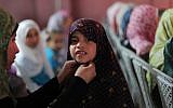 A Palestinian mother fixes her daughter's hijab in Gaza. (photo credit: Wissam Nassar/Flash90)