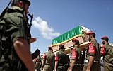 Palestinian Hamas militants hold a symbolic coffin of Maisara Abu Hamdiyeh, an Israeli-held prisoner who died of cancer while in detention, during a protest against his death in Gaza City on April 04, 2013 (photo credit: Wissam Nassar/FLASH90)
