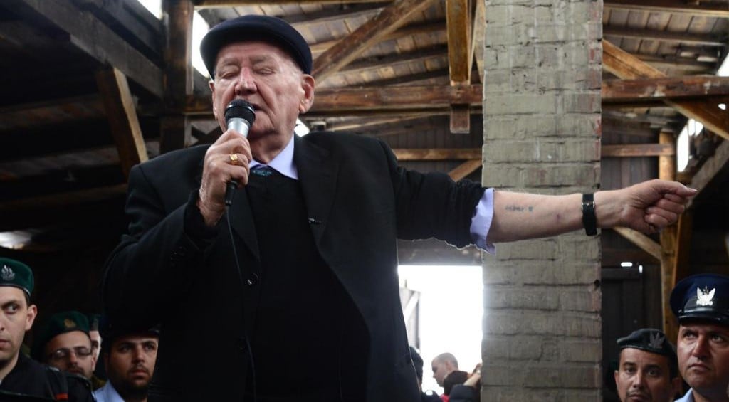 A Holocaust survivor talks to an Israeli delegation about his years at the Auschwitz death camp, as the delegation visits Auschwitz, Poland, as part of the "March of the Living" on the eve of Holocaust Remembrance Day, April 7, 2013. (Photo credit: Moshe Milner/GPO/FLASH90) A Holocaust survivor talks to an Israeli delegation about his years at the Auschwitz death camp, as the delegation visits Auschwitz, Poland, as part of the "March of the Living" on the eve of Holocaust Remembrance Day, April 7, 2013. (Photo credit: Moshe Milner/GPO/FLASH90)