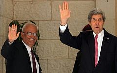 US Secretary of State John Kerry (R) and Palestinian chief negotiator Saeb Erekat wave before a meeting with Palestinian Authority President Mahmoud Abbas at the presidential compound in the West Bank city of Ramallah January 4, 2014. (Issam Rimawi/Flash90)