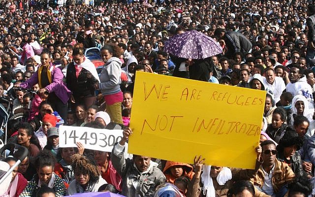 Thousands of asylum seekers from Eritrea and Sudan protest the Israeli government's neglect to review asylum requests, and the state's detention policies, at a demonstration held at Rabin Square, central Tel Aviv, on January 5, 2013. (photo credit: Roni Schutzer/Flash90) Thousands of asylum seekers from Eritrea and Sudan protest the Israeli government's neglect to review asylum requests, and the state's detention policies, at a demonstration held at Rabin Square, central Tel Aviv, on January 5, 2013. (photo credit: Roni Schutzer/Flash90)