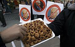 Palestinians hand out sweets as they celebrate the passing of former Israeli prime minister Ariel Sharon in Khan Younis in the southern Gaza Strip, January 11, 2014 (photo credit: Abed Rahim Khatib/Flash90)
