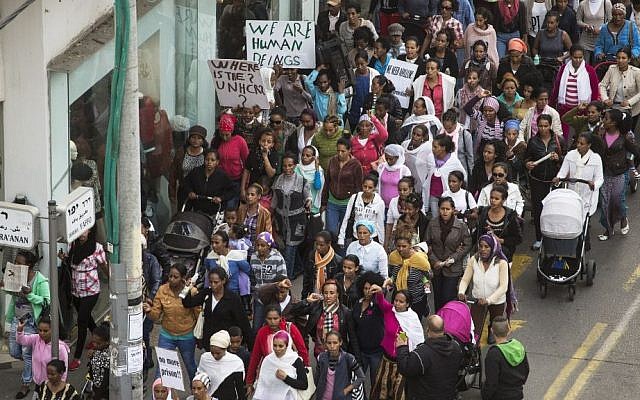 Hundreds of female African asylum seekers and their children participate in a protest march towards the US Embassy in Tel Aviv on January 15, 2014, calling on the Israeli government to grant them asylum and work rights. (photo credit: Matanya Tausig/Flash90) Hundreds of female African asylum seekers and their children participate in a protest march towards the US Embassy in Tel Aviv on January 15, 2014, calling on the Israeli government to grant them asylum and work rights. (photo credit: Matanya Tausig/Flash90)