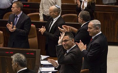 Knesset members give a standing ovation after the speech by Canadian Prime Minister Stephen Harper, on Monday, January 20, 2014. (Photo credit: Flash 90)