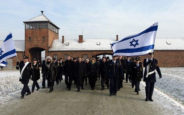 Israeli Knesset members walks through the main gate of the Auschwitz concentration camp, in Poland, January 28, 2014 (photo credit: Haim Zach/GPO/Flash90)