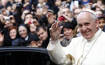Pope Francis waves as he leaves Rome's Jesus' Church to celebrate a mass with the Jesuits, on the occasion of the order's titular feast on Friday, January 3, 2014. (photo credit: AP/Riccardo De Luca)