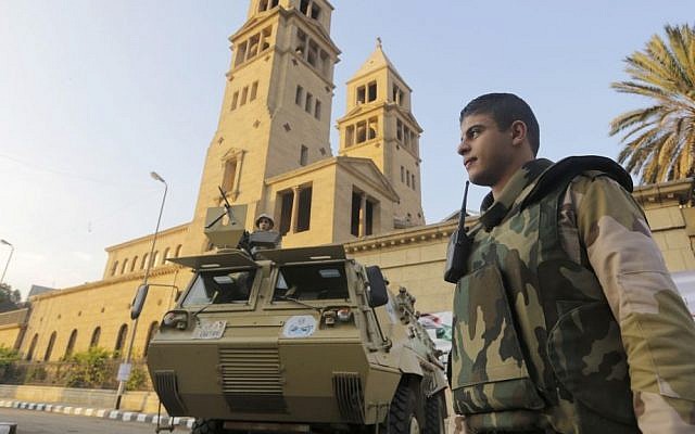 An armored military vehicles secures Cairo's St. Mark's Cathedral on Monday (photo credit: AP/Amr Nabil) An armored military vehicles secures Cairo's St. Mark's Cathedral on Monday (photo credit: AP/Amr Nabil)