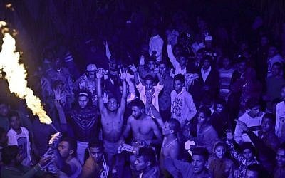 In this Thursday, December 19, 2013 photo, Egyptian youths dance, to "Mahraganat," Arabic for "festivals," music, a rapid-fire electronic beat, mixed with hypnotic rhythms, during a bachelors party, in El-Marg, a suburb northeast of Cairo, Egypt. (photo credit: AP Photo/Nariman El-Mofty)