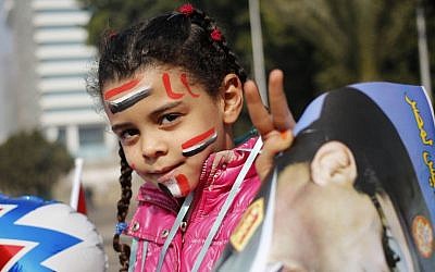 An Egyptian girl holds a poster of Egypt's Defense Minister, Gen. Abdel-Fattah el-Sissi, in Tahrir Square, the epicenter of the 2011 uprising, in Cairo, Egypt, Saturday, Jan. 25, 2014. Egyptian riot police have fired tear gas to disperse hundreds of supporters of ousted Islamist President Mohammed Morsi protesting as the country marks the third anniversary of the 2011 uprising, as supporters of the military gathered in rival rallies in other parts of the capital. (AP Photo/Hassan Ammar)
