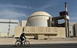 A worker rides a bicycle in front of the reactor building of the Bushehr nuclear power plant, just outside the southern city of Bushehr, Iran,  Oct. 26, 2010. (AP/Mehr News Agency, Majid Asgaripour)